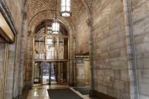 Interior of a building entryway featuring an arched entrance
