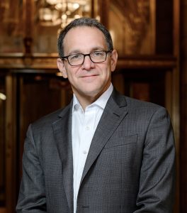 man wearing gray suit and glasses