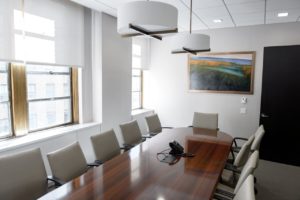 Conference room with long wooden table and chairs around it