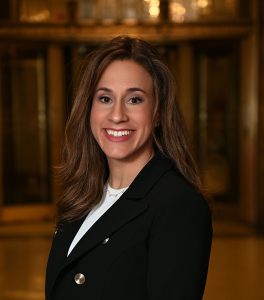 Woman smiling and wearing black blazer