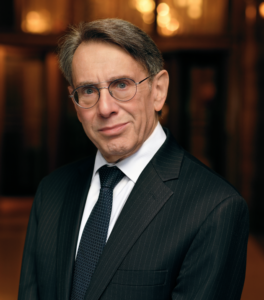 Man in black suit and white shirt.